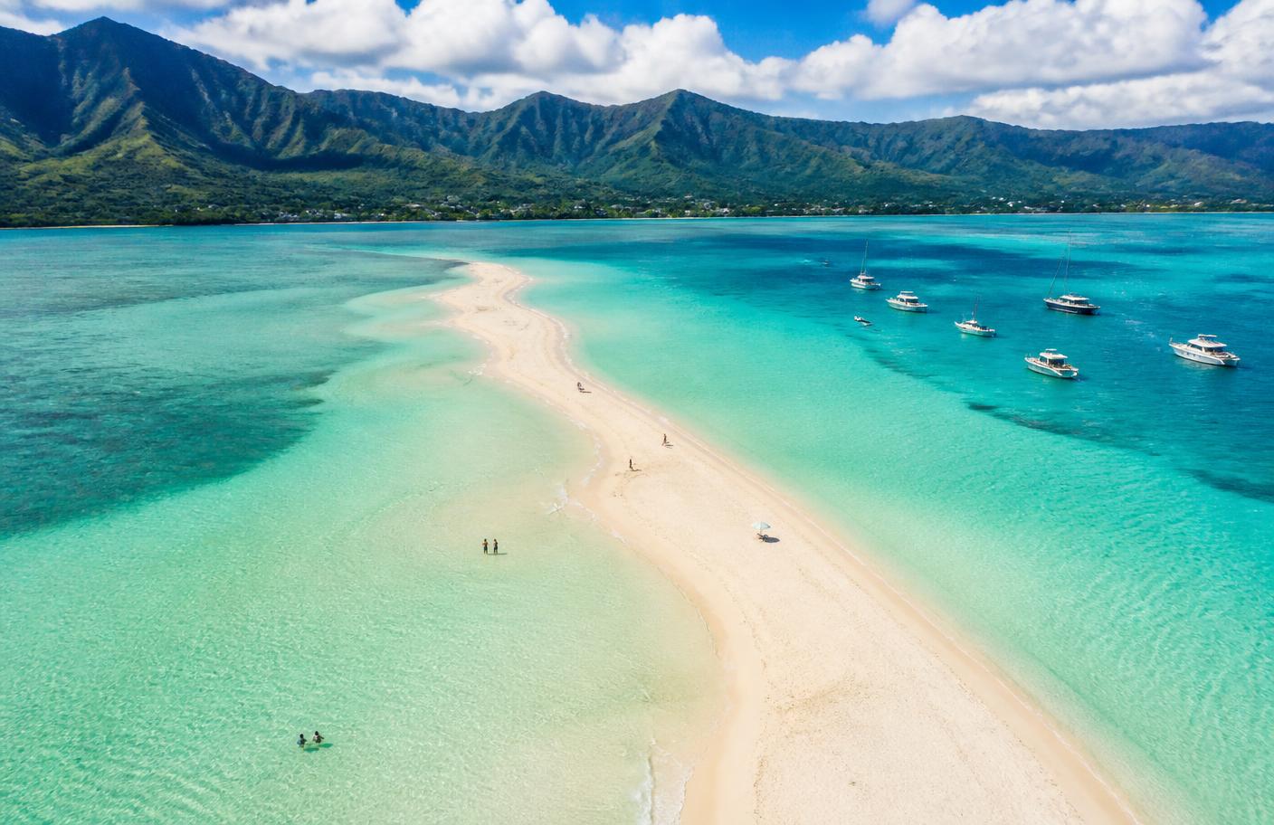 Placeholder — the Kaneohe Bay sandbar from above with boats anchored nearby