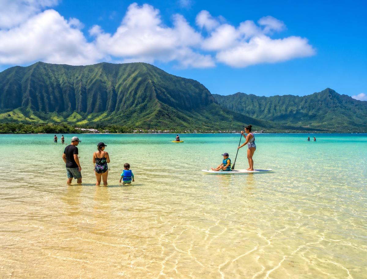 Placeholder — families wading on the Kaneohe Bay sandbar with the Koolau mountains behind